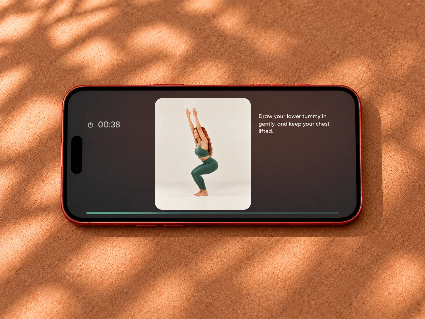 Yoga Space sequence player showing Chair Pose on a phone resting on a cork surface