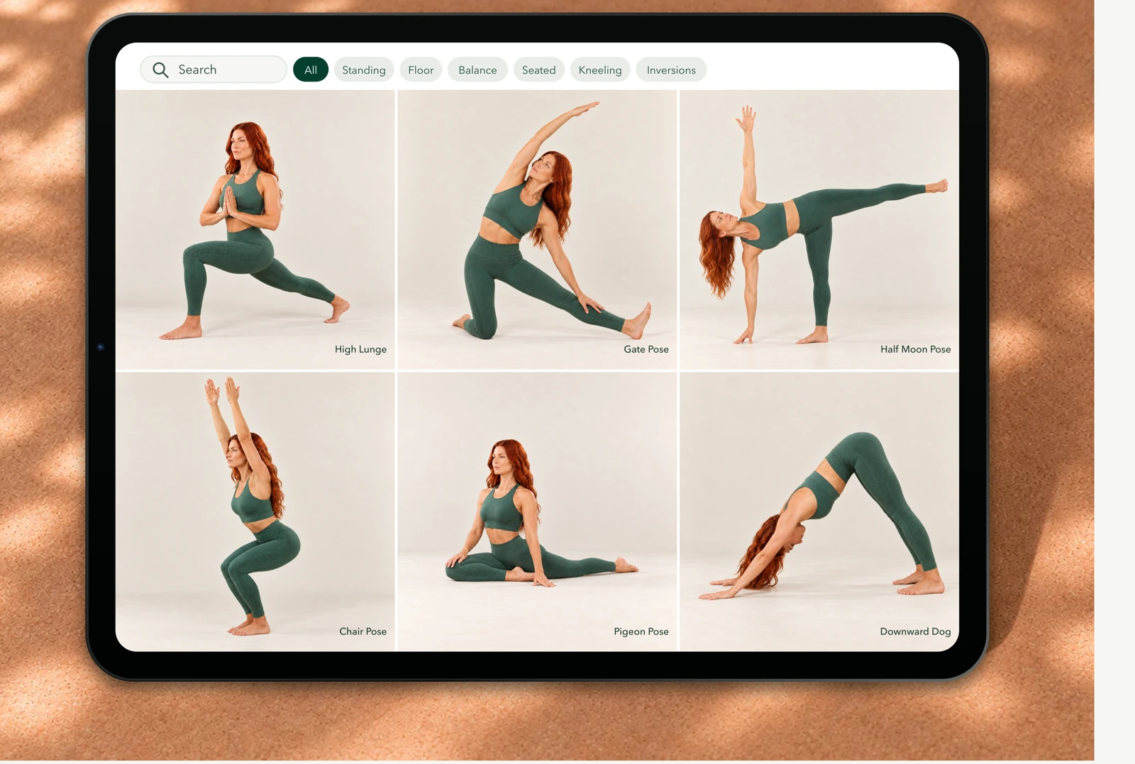 Yoga Space pose library with six pose cards shown on an iPad on a sunlit cork surface